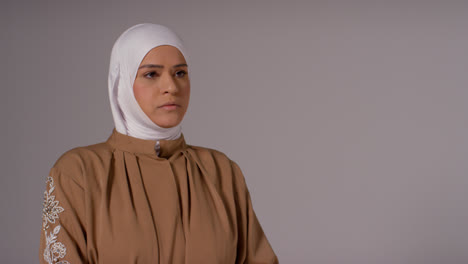 Studio-Head-And-Shoulders-Portrait-Of-Muslim-Woman-Wearing-Hijab-Praying-8